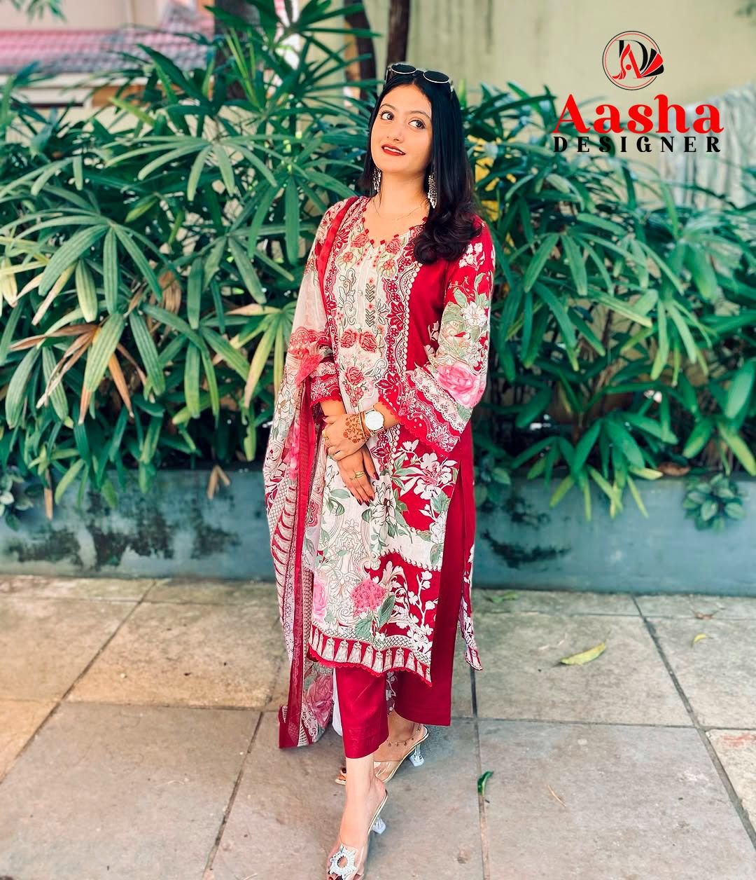 Model wearing a crimson maroon Aasha Designer pure cotton Pakistani suit with heavy embroidered neckline patches.